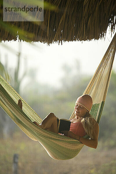 Young woman relaxing in hammock in Mexico.