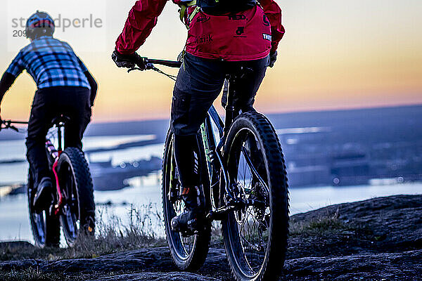 Two people riding bicycles at dawn  Duluth  Minnesota  USA