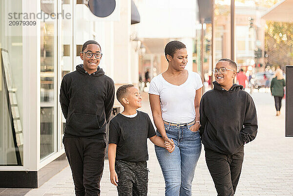 Mother walking downtown with sons