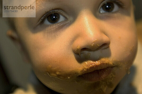 Close-up of a boy's face after eating a peanut butter sandwich