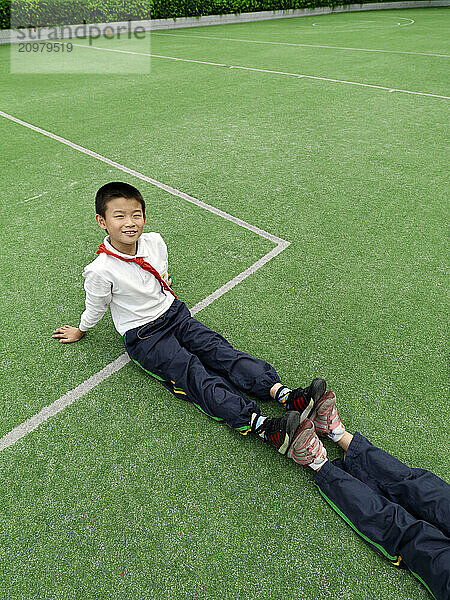 School children stretching during a physical fitness class.