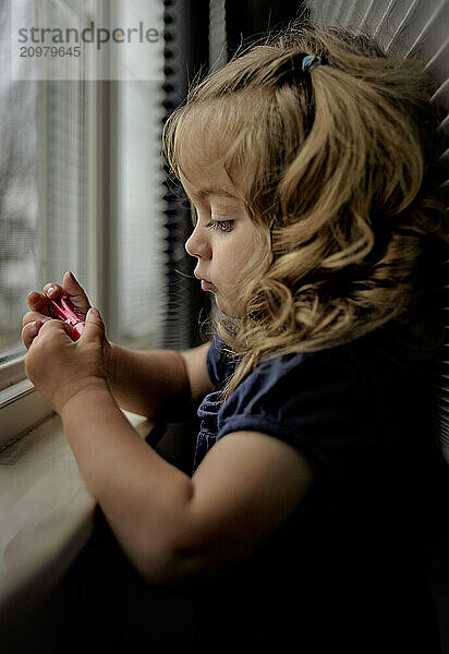 Side view beautiful toddler blonde curls with lipstick