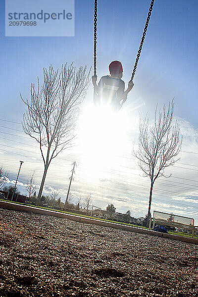 Young boy playing in playground in Sacramento  CA.