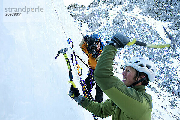 A photographer photographs an ice climber in Calif.