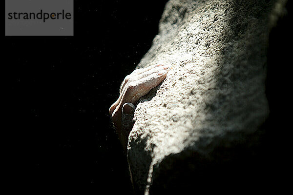 Climber slapping sloper hold in Squamish  BC  Canada.