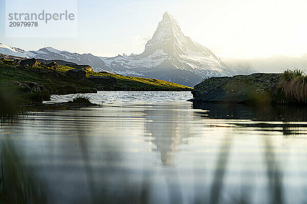 Foggy sunset over Matterhorn and Stellisee lake at spring  Switzerland