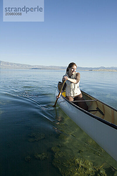 Young woman canoeing on Mono Lake. Lee Vining  CA