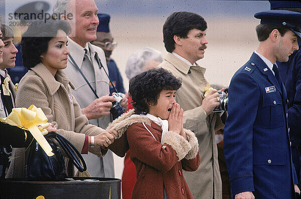 The wife and daughter of a soldier returning home after serving in