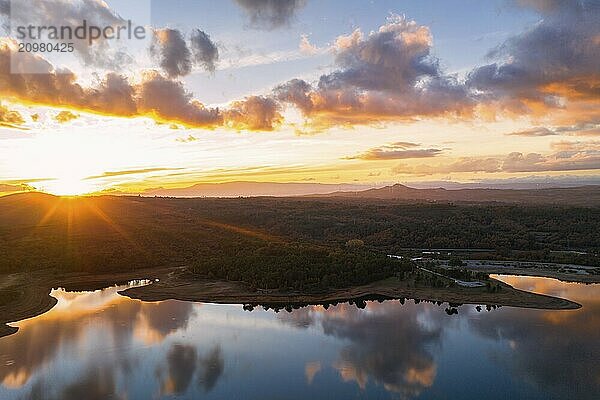 Drone aerial view of a lake reservoir of a dam with perfect reflection on the water of the sunset in Sabugal  Portugal  Europe