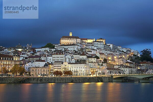 Coimbra city view at night with Mondego river and beautiful historic buildings  in Portugal