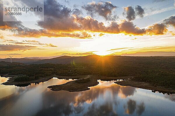 Drone aerial view of a lake reservoir of a dam with perfect reflection on the water of the sunset in Sabugal  Portugal  Europe