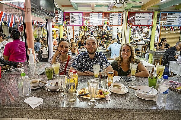 Tourists sitting at a table at a food stall  Mercado Central de San José  San José  Costa Rica  Central America