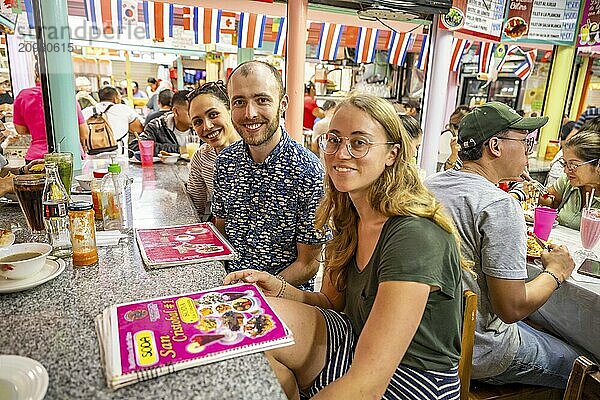 Tourists sitting at a table at a food stall  Mercado Central de San José  San José  Costa Rica  Central America