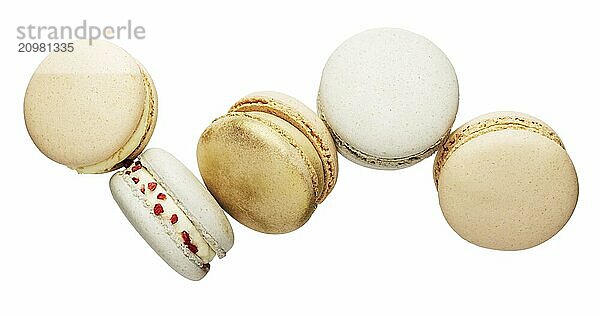 Isolated on white background white  yellow  gold macaron cookies flying  falling in motion or levitating. Colorful  sweet small French macaroon cakes. Five full cookies isolate.