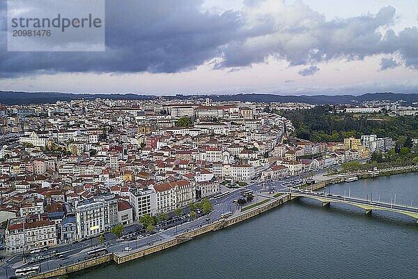 Coimbra drone aerial city view at sunset with Mondego river and beautiful historic buildings  in Portugal