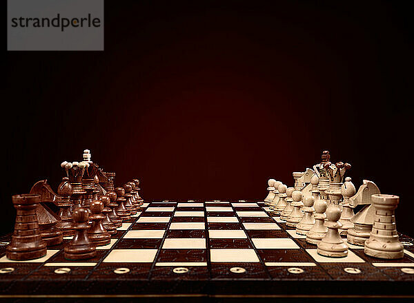 Chessboard with chess pieces  board game on brown background