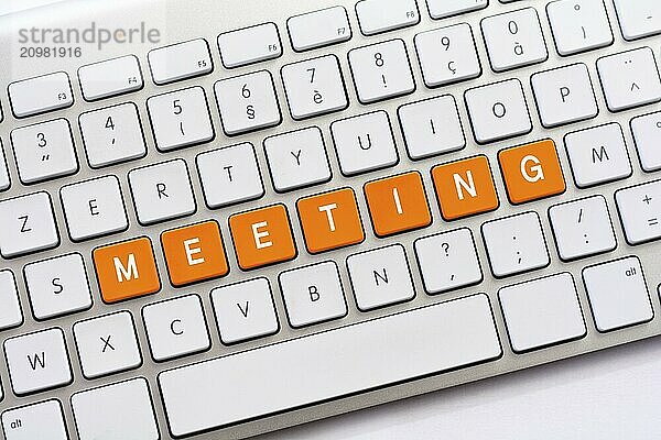 MEETING writing on white keyboard