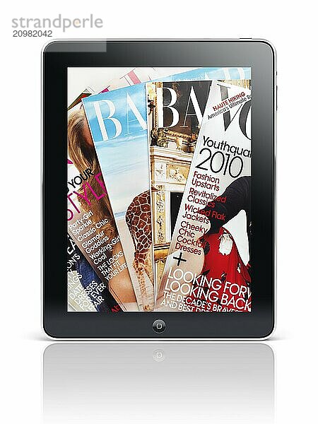 Apple iPad tablet with fashion magazine covers on its display screen isolated with clipping path on white background. High quality photo