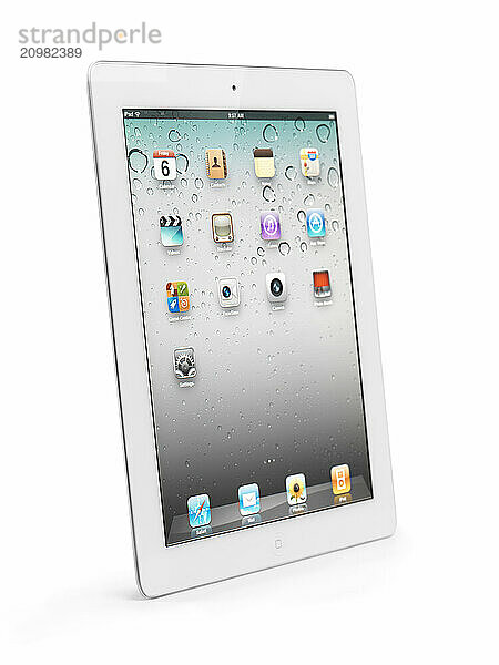 White Apple iPad 2 tablet computer with desktop icons on its display. Isolated with clipping path on white background