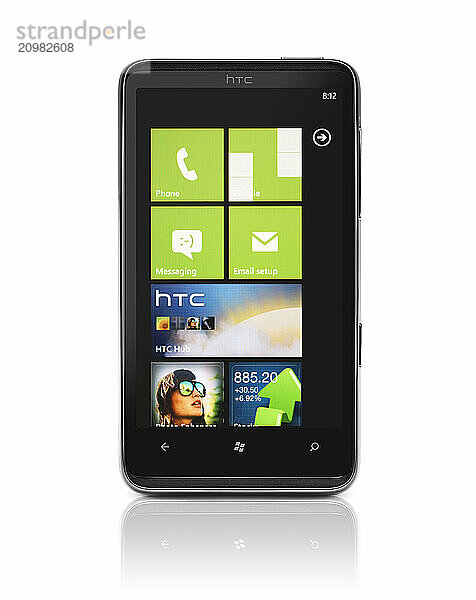 Windows 7 phone. HTC HD7 smartphone with desktop tiles on its display isolated with clipping path on white background. High quality photo