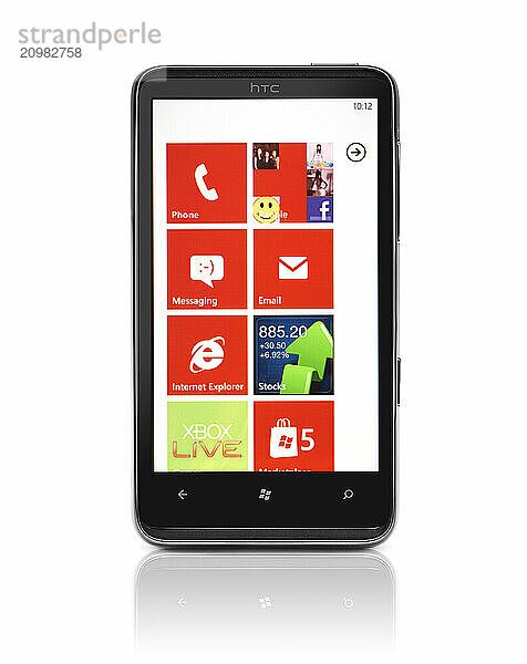 Windows 7 phone. HTC HD7 smartphone with desktop tiles on its display isolated with clipping path on white background. High quality photo