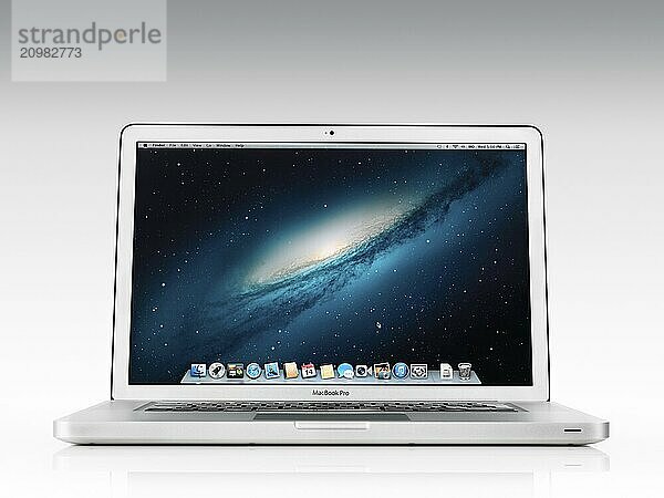 Apple Macbook Pro laptop computer front view with desktop on its display isolated on white background with clipping path