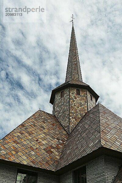 Closeup of the rooftop of the little church in Dombas village in Norway under a cloudy sky