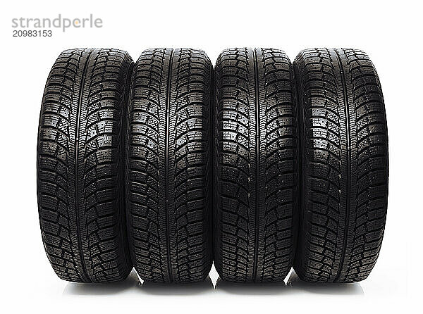 Set of four winter tires  car snow tyres isolated on white background