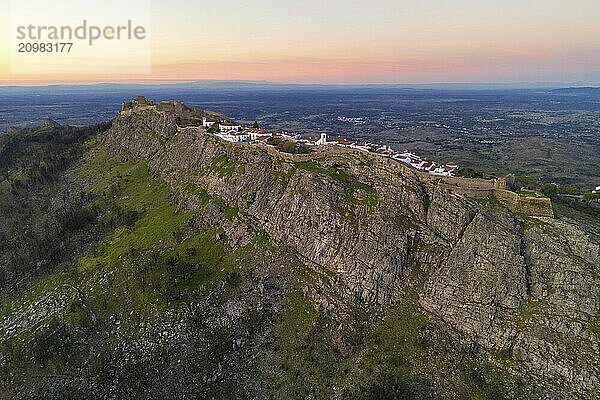 Marvao drone aerial view of the historic village and Serra de Sao Mamede mountain at sunset  in Portugal