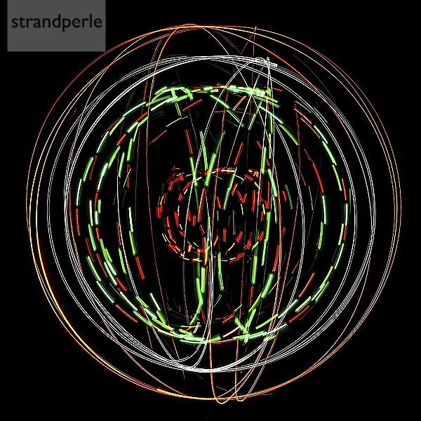 Abstract round structure made of coloured light painting against a black background