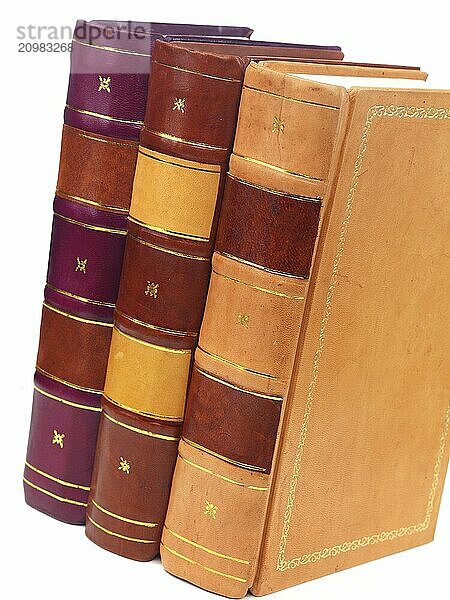 Three hardcover leather bound books on white background