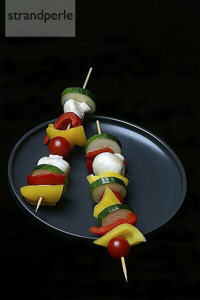 Colourful vegetable skewers on a plate  barbecue skewers