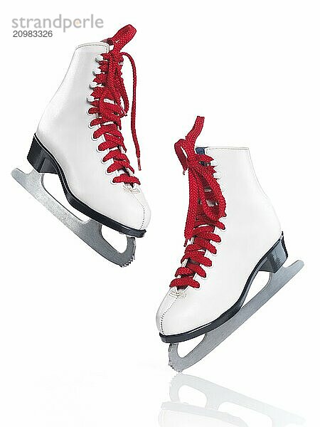 White ice skates with red laces artistic still life isolated on white background