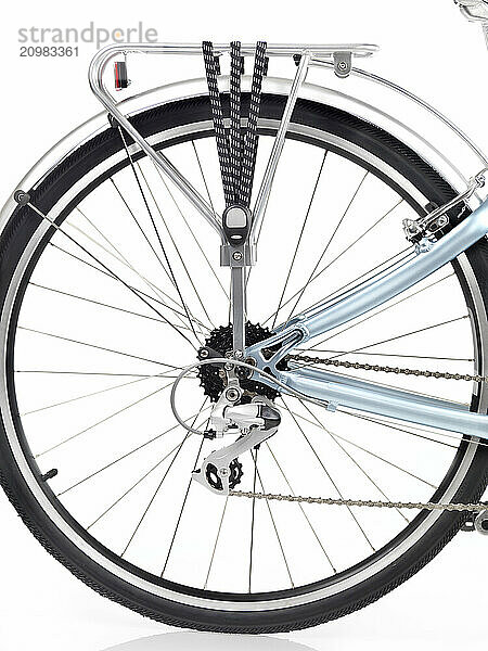 Bicycle rear wheel with a rack  set of gears and a derailleur isolated on white background