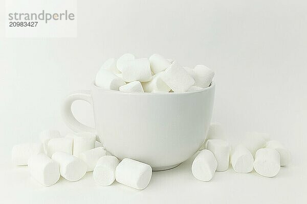 Marshmallow in the cup on the white background.