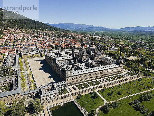 Aerial view of a historic monastery and town with mountains in the background on a sunny day  aerial view  Real Sitio de San Lorenzo de El Escorial  Royal Seat of St Lawrence of El Escorial  palace and monastery complex  San Lorenzo de El Escorial  Madrid  Spain  UNESCO World Heritage Site  Europe