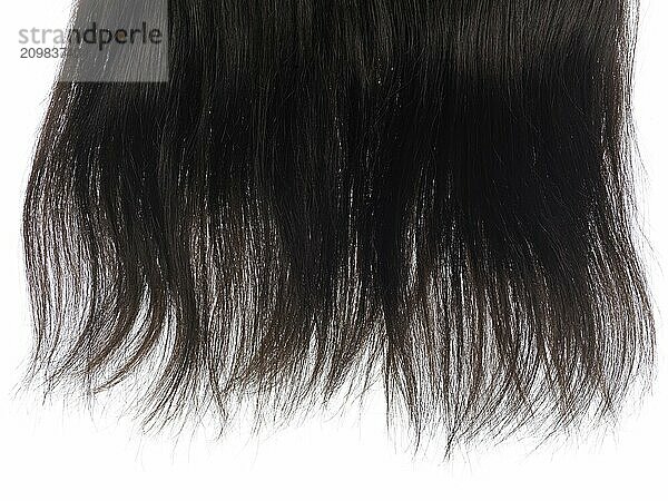 Lock of dark brown hair extensions with real hair isolated texture on white background