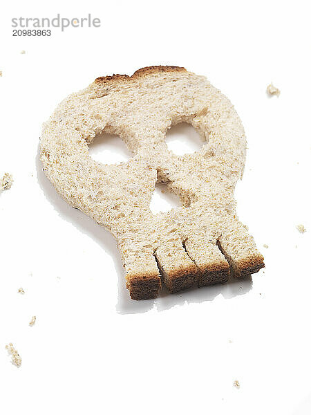 Skull made out of bread isolated on white background