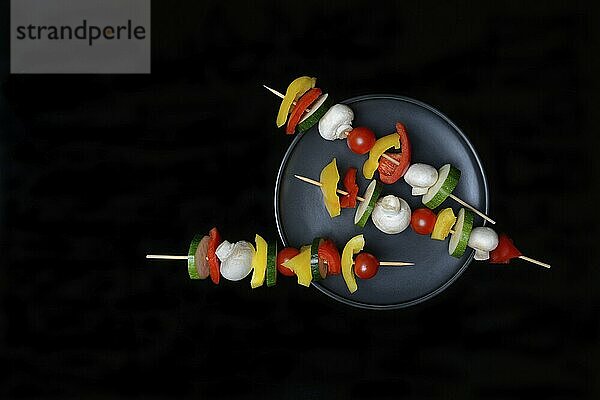 Colourful vegetable skewers on a plate  barbecue skewers