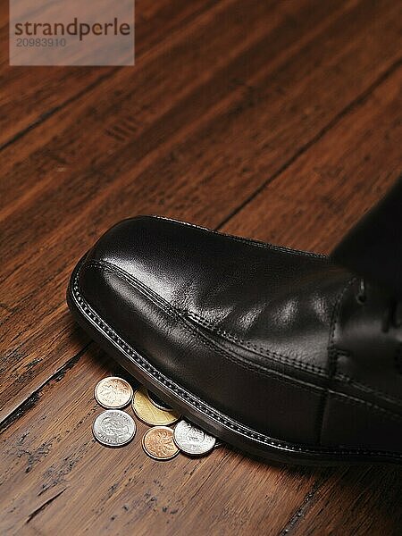 Closeup of a man shoe standing on change  coins  money found on the floor concept