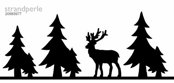 Deer figure sawn out of wood with dark edges and wooden fir trees cut out on white