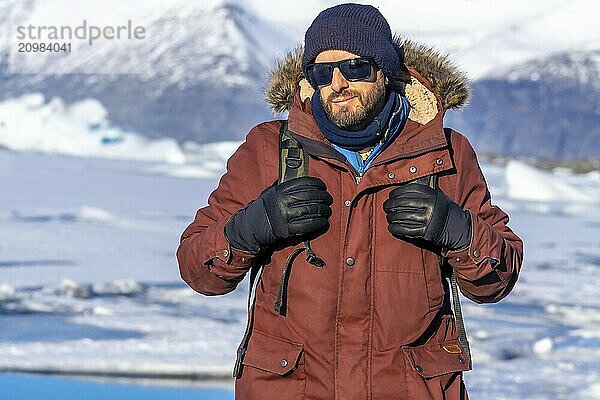 Portrait of a hiker on the frozen lake of Jokulsarlon glacier in Iceland