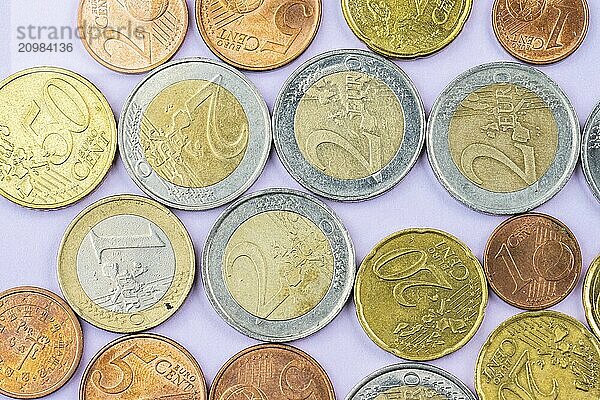 Assortment of Euro coins on purple background