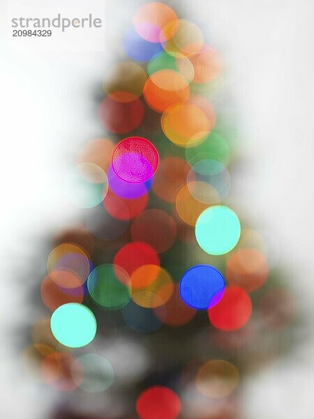 Out of focus decorated Christmas tree on white background