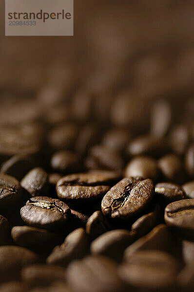 Stock photo of Coffee beans macro with artistic shallow focus background texture