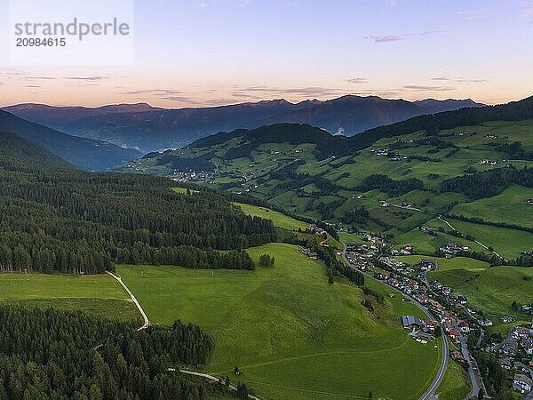 Aerial Drone shot of Santa Magdalena St Maddalena Val di Funes in Dolomites Italian Alps at sunrise