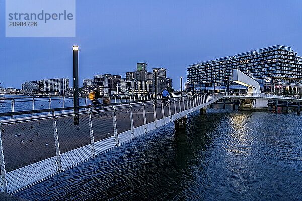 The former Fenix warehouse  left  from 1923  destroyed in the war  renovated in 2019  converted into a residential and commercial building  with hotel  flats  restaurants  offices  warehouses  on the Rijnhaven harbour basin  Rijnhavenbrug  bridge  Rotterdam  Netherlands