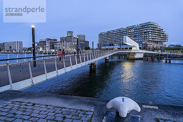 The former Fenix warehouse  left  from 1923  destroyed in the war  renovated in 2019  converted into a residential and commercial building  with hotel  flats  restaurants  offices  warehouses  on the Rijnhaven harbour basin  Rijnhavenbrug  bridge  Rotterdam  Netherlands