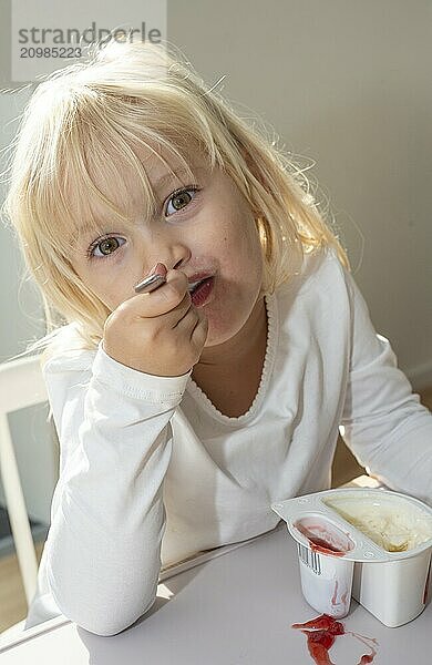 Portrait of blonde girl  3 years old  having lunch in Ystad  Skåne County  Sweden  Scandinavia  Europe