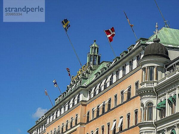 Building with several flags on the roof and bluish-green dome  stockholm  baltic sea  sweden  scandinavia